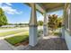 Front porch with stone pavers, pillars, metal railing, and view of lake at 13755 Benavente Ave, Orlando, FL 32827