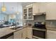 Bright kitchen features granite counters, stainless steel appliances, and an island with a sink at 13755 Benavente Ave, Orlando, FL 32827