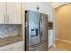 Bright kitchen features stainless steel appliances, white cabinets, and granite countertops at 13755 Benavente Ave, Orlando, FL 32827