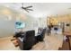 Open-concept living room with a ceiling fan, modern furniture, and view into the kitchen area at 13755 Benavente Ave, Orlando, FL 32827