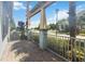 Outdoor patio featuring stone pavers, pillars, metal railing, and view of lake and trees at 13755 Benavente Ave, Orlando, FL 32827