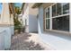 Side patio featuring stone pavers, pillars, metal railing, exterior wall and window at 13755 Benavente Ave, Orlando, FL 32827