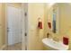 Bright powder room boasting a white vanity and gold fixtures at 13755 Benavente Ave, Orlando, FL 32827