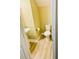 Small half-bath featuring wood-look floors, a toilet, and a pedestal sink at 13755 Benavente Ave, Orlando, FL 32827
