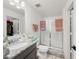 Bathroom with white walls, shower, toilet and granite countertop sink at 1471 Mirabella Cir, Davenport, FL 33897