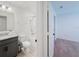 Bathroom with white walls, shower over bath, toilet and granite countertop sink at 1471 Mirabella Cir, Davenport, FL 33897