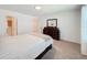 Bedroom with carpet, dresser and mirror, bathroom entrance and natural light at 1471 Mirabella Cir, Davenport, FL 33897