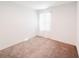 Empty bedroom featuring neutral carpet, soft light and a large window at 1471 Mirabella Cir, Davenport, FL 33897