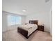 Bright bedroom features a large window, neutral carpet, and dark wood furniture at 1471 Mirabella Cir, Davenport, FL 33897