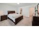 Well-lit bedroom featuring neutral carpet, a large window, and dark wood furniture set at 1471 Mirabella Cir, Davenport, FL 33897