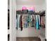 Walk-in closet with hanging clothes and storage; pink balloons on the top shelf at 1471 Mirabella Cir, Davenport, FL 33897