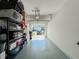 Functional garage with ample storage space and a view of the driveway and street at 1471 Mirabella Cir, Davenport, FL 33897