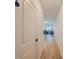 Hallway with wood floors leading to a dining area and living room flooded with natural light at 1471 Mirabella Cir, Davenport, FL 33897