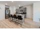 Modern kitchen with gray cabinets, granite countertops, stainless steel appliances, and an island with seating at 1471 Mirabella Cir, Davenport, FL 33897