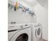Convenient laundry room equipped with Samsung washer and dryer, shelving, and ample storage at 1471 Mirabella Cir, Davenport, FL 33897