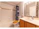 Bathroom featuring a shower-tub combination and a wood-finish vanity at 14831 Yorkshire Run Dr, Orlando, FL 32828