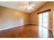 Bedroom featuring hardwood flooring, a ceiling fan, and sliding glass doors to the lanai at 14831 Yorkshire Run Dr, Orlando, FL 32828