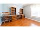 Bedroom with built-in shelving, wood flooring, and a window providing natural light at 14831 Yorkshire Run Dr, Orlando, FL 32828