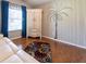 Cozy bedroom featuring hardwood floors and a decorative palm tree wall art piece at 14831 Yorkshire Run Dr, Orlando, FL 32828