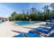 Community pool with plenty of lounge chairs, umbrellas, and mature landscaping at 14831 Yorkshire Run Dr, Orlando, FL 32828