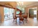 Dining area featuring tile flooring, a chandelier, a sliding glass door, and wood furnishings at 14831 Yorkshire Run Dr, Orlando, FL 32828