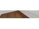 Close up of hardwood floor with white baseboard and white walls at 14831 Yorkshire Run Dr, Orlando, FL 32828