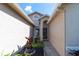 Inviting front entry featuring a decorative wreath and landscaped flowerbeds at 14831 Yorkshire Run Dr, Orlando, FL 32828
