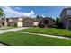 Charming single-story home featuring a well-manicured lawn and a two-car garage at 14831 Yorkshire Run Dr, Orlando, FL 32828