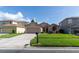 Charming single-story home featuring a well-manicured lawn and a two-car garage at 14831 Yorkshire Run Dr, Orlando, FL 32828