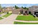Well-maintained single-Gathering home featuring a manicured front lawn and two-car garage at 14831 Yorkshire Run Dr, Orlando, FL 32828