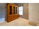 Hallway featuring wood storage cabinet, tile flooring, and convenient access to the front door at 14831 Yorkshire Run Dr, Orlando, FL 32828