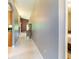 Hallway with tile flooring leading to rooms, offering a glimpse of natural light at 14831 Yorkshire Run Dr, Orlando, FL 32828