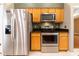 Modern kitchen features stainless steel appliances, and wooden cabinetry, perfect for cooking at 14831 Yorkshire Run Dr, Orlando, FL 32828