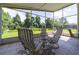 Comfortable screened lanai with outdoor seating and tranquil views of the lush green backyard at 14831 Yorkshire Run Dr, Orlando, FL 32828