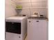 Functional laundry room equipped with a modern washer and dryer for convenience at 14831 Yorkshire Run Dr, Orlando, FL 32828