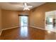 Open living room featuring wood floors, ceiling fan, and sliding glass doors to an outdoor seating area at 14831 Yorkshire Run Dr, Orlando, FL 32828