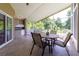 Spacious screened-in patio with ample seating and an outdoor kitchenette overlooking a lush yard at 14831 Yorkshire Run Dr, Orlando, FL 32828