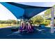 Community playground with blue shade covering slides, steps, and other fun features at 14831 Yorkshire Run Dr, Orlando, FL 32828