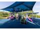 Community playground with slides, steps, and climbing features all covered by a blue shade at 14831 Yorkshire Run Dr, Orlando, FL 32828