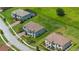 Aerial view of beautiful homes with well-manicured lawns and tree lined streets in a residential neighborhood at 1551 Gateway Ln, Kissimmee, FL 34746