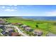 Gorgeous aerial view of homes near a scenic lake with expansive green space and blue skies at 1551 Gateway Ln, Kissimmee, FL 34746