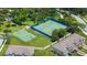 Aerial view of community amenities including tennis court and basketball court next to homes at 1551 Gateway Ln, Kissimmee, FL 34746