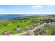 Scenic aerial shot of a residential neighborhood near a lake, surrounded by lush green fields at 1551 Gateway Ln, Kissimmee, FL 34746