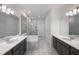 A spacious bathroom featuring dual vanities, a modern bathtub and a glass shower at 1551 Gateway Ln, Kissimmee, FL 34746