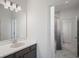 Well-appointed bathroom with a marble-tiled shower, gray vanity, and modern fixtures at 1551 Gateway Ln, Kissimmee, FL 34746