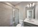 This contemporary bathroom has a glass shower and a gray vanity with a white countertop at 1551 Gateway Ln, Kissimmee, FL 34746