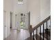 Inviting foyer with tile floors, staircase, and an open door to a front yard view at 1551 Gateway Ln, Kissimmee, FL 34746