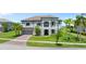 Beautiful two-story home with a well-manicured lawn and palm trees at 1551 Gateway Ln, Kissimmee, FL 34746