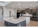Well-equipped kitchen with gray cabinets, tile backsplash, stainless steel appliances, and quartz countertops at 1551 Gateway Ln, Kissimmee, FL 34746