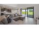 Comfortable living room boasts a sectional sofa, ceramic tile floors and sliding glass doors to the covered patio at 1551 Gateway Ln, Kissimmee, FL 34746